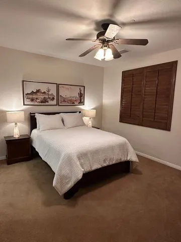 a bedroom with a bed and lamp