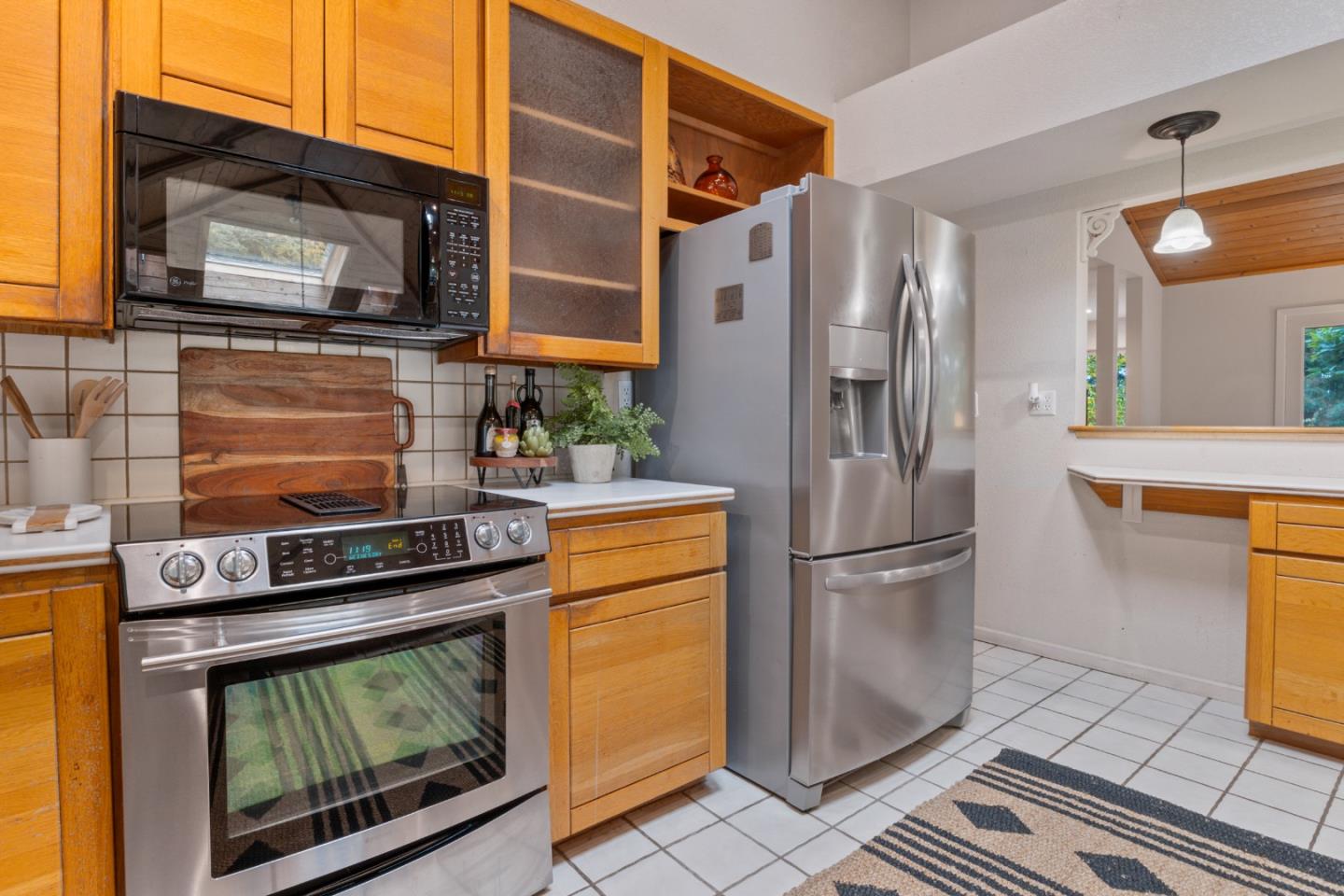 2345 Laurel Glen Road Soquel, CA 95073 - Photo 11 of 63 a kitchen with stainless steel appliances granite countertop a refrigerator a stove and a sink with wooden floor