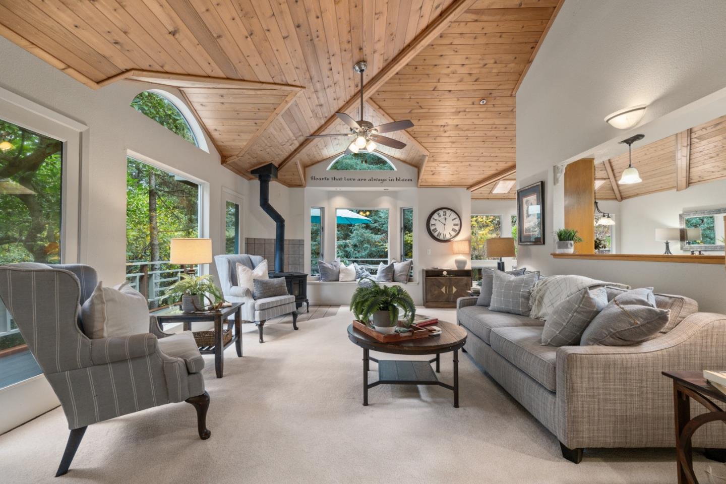 2345 Laurel Glen Road Soquel, CA 95073 - Photo 3 of 63 a living room with furniture a fireplace a large window and potted plants