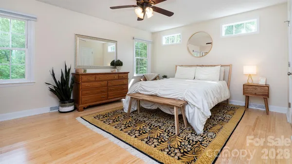 a bed room with a bed and a chandelier