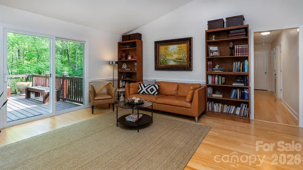 a living room with furniture and a book shelf