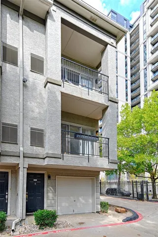 a front view of a building with a garden