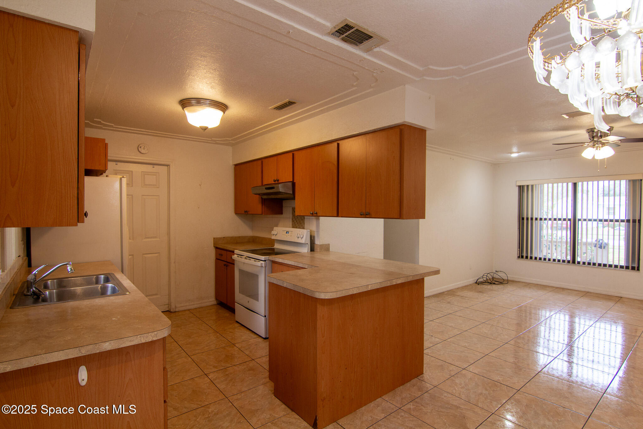 981 Palmer Street Rockledge, FL 32955 - Photo 16 of 38 a kitchen with stainless steel appliances granite countertop a sink stove and refrigerator