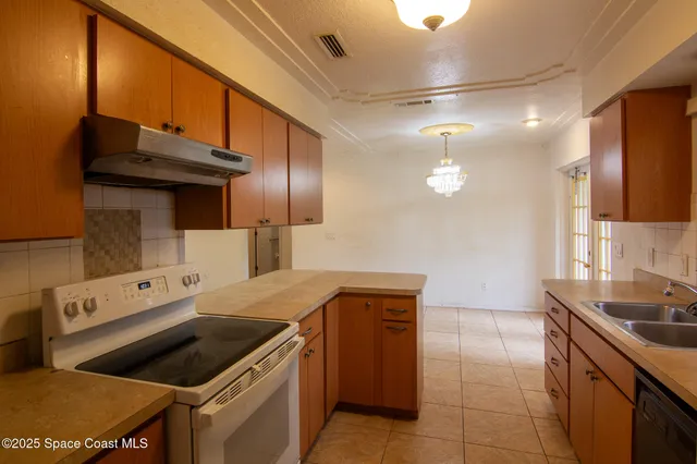 a kitchen that has a sink and a stove