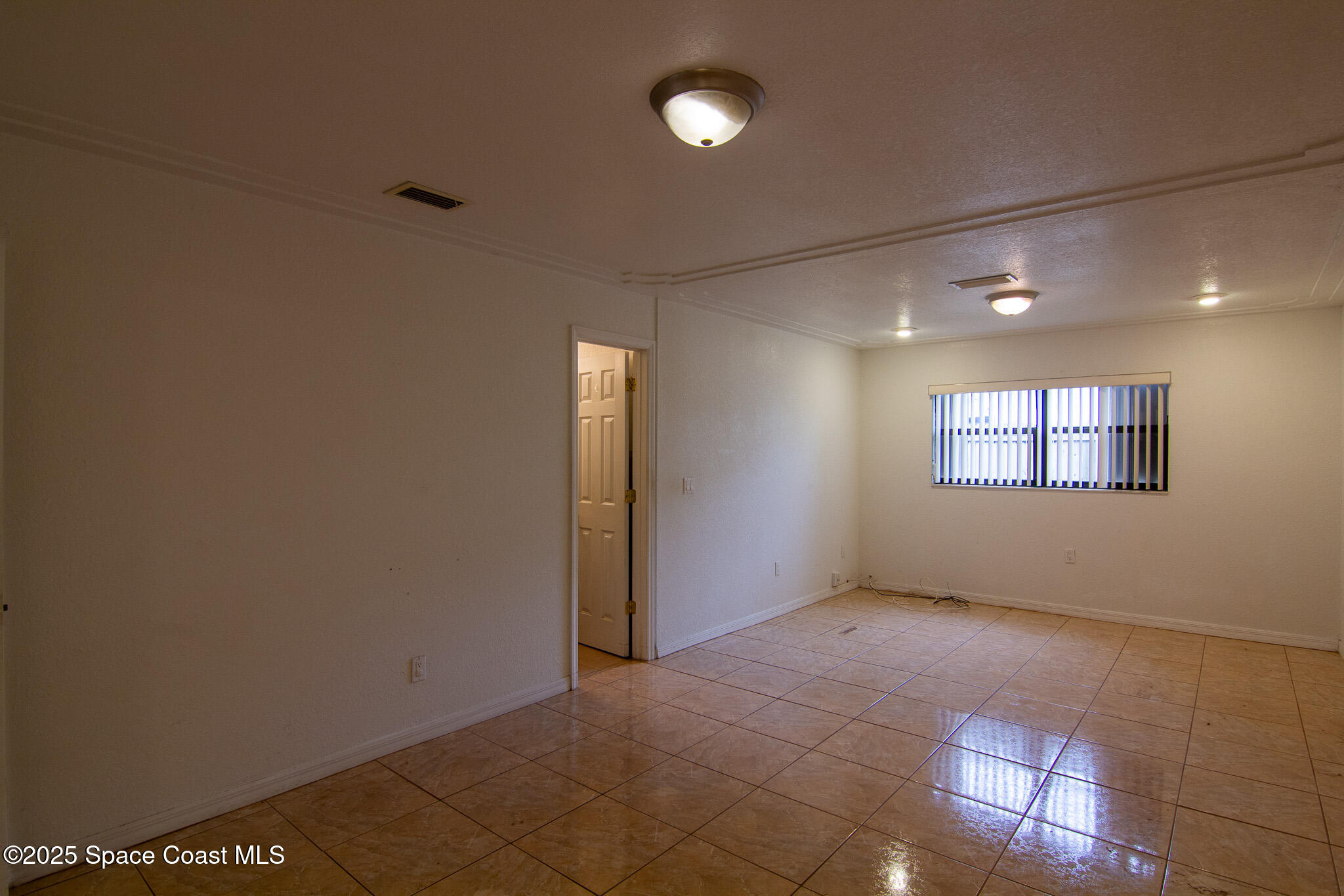 981 Palmer Street Rockledge, FL 32955 - Photo 19 of 38 a view of an empty room with a window