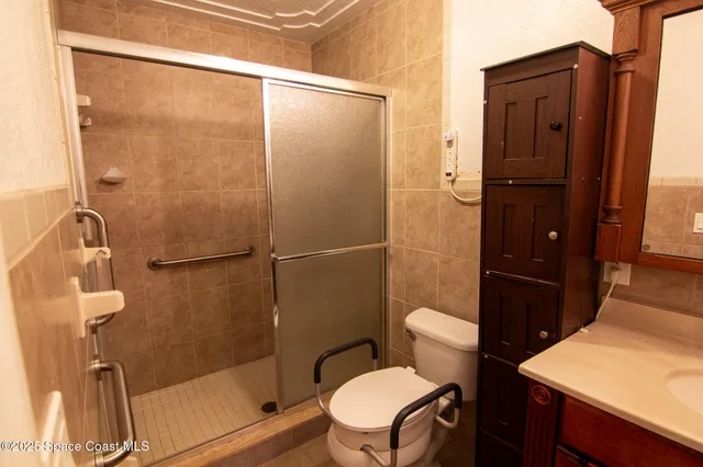 a bathroom with a toilet a sink and shower