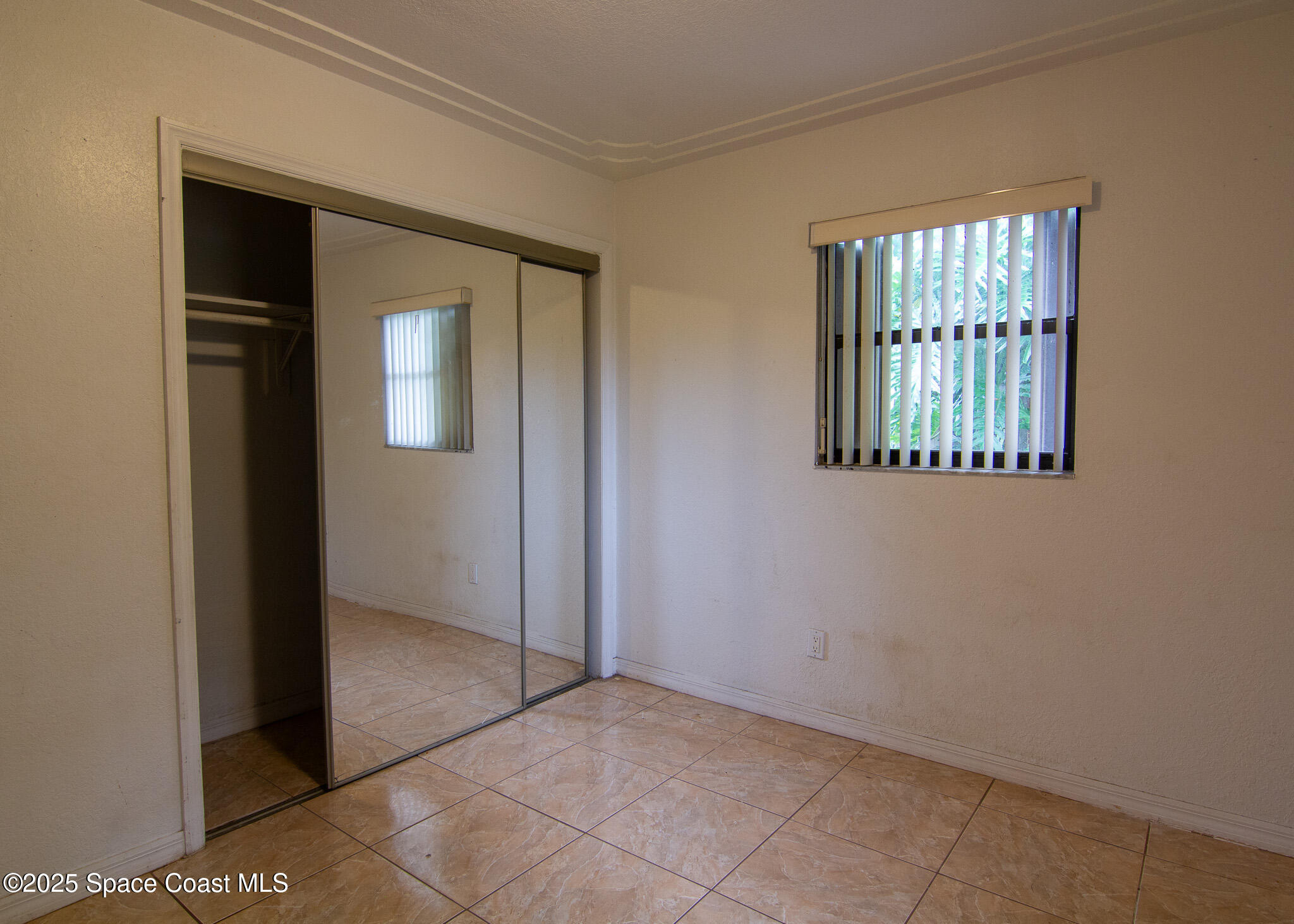 981 Palmer Street Rockledge, FL 32955 - Photo 26 of 38 an empty room with windows and closet