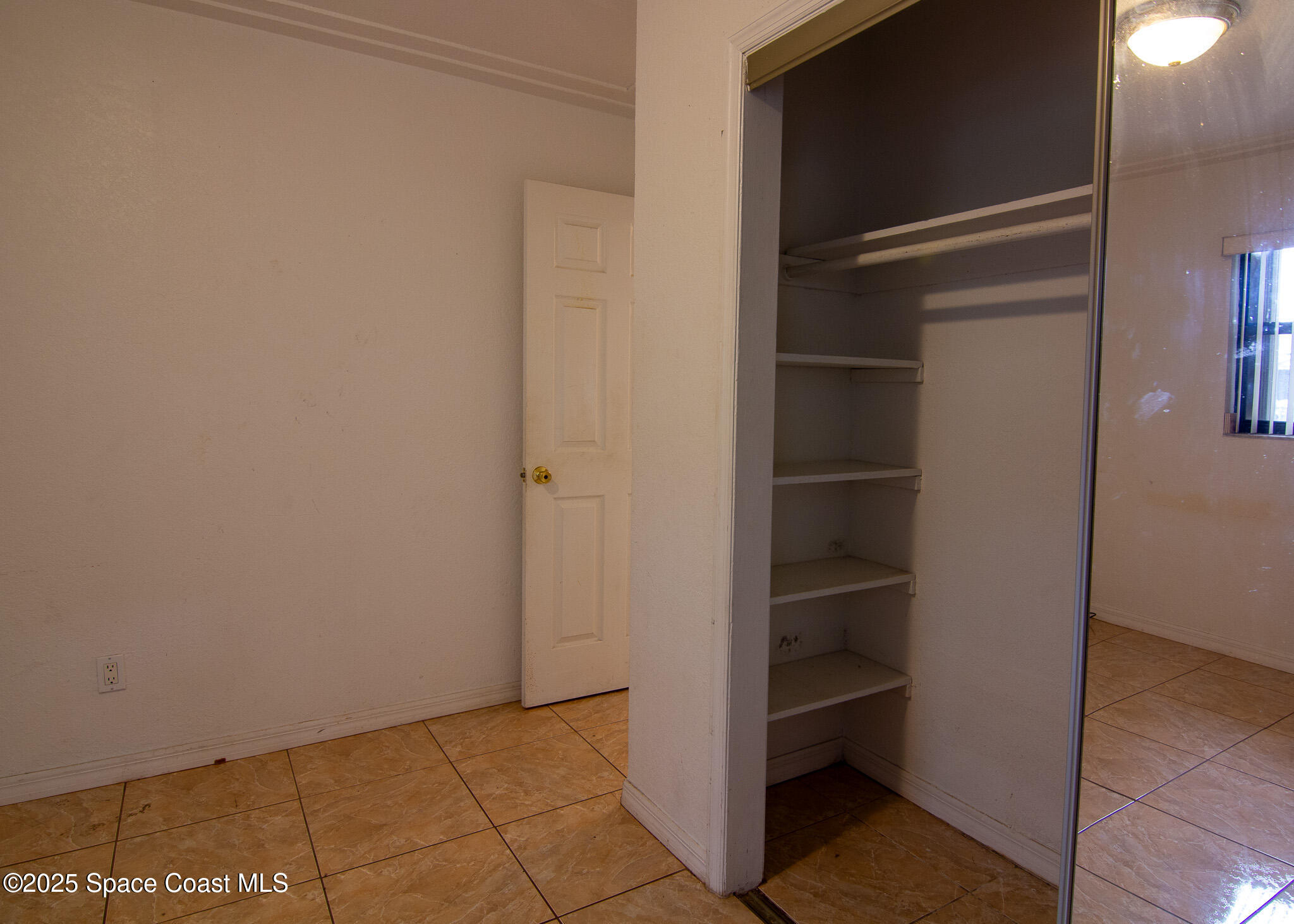 981 Palmer Street Rockledge, FL 32955 - Photo 27 of 38 a view of an empty walk in closet
