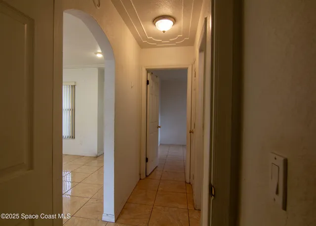 a view of a hallway with wooden shelves