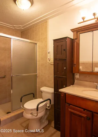 a bathroom with a toilet a sink and shower