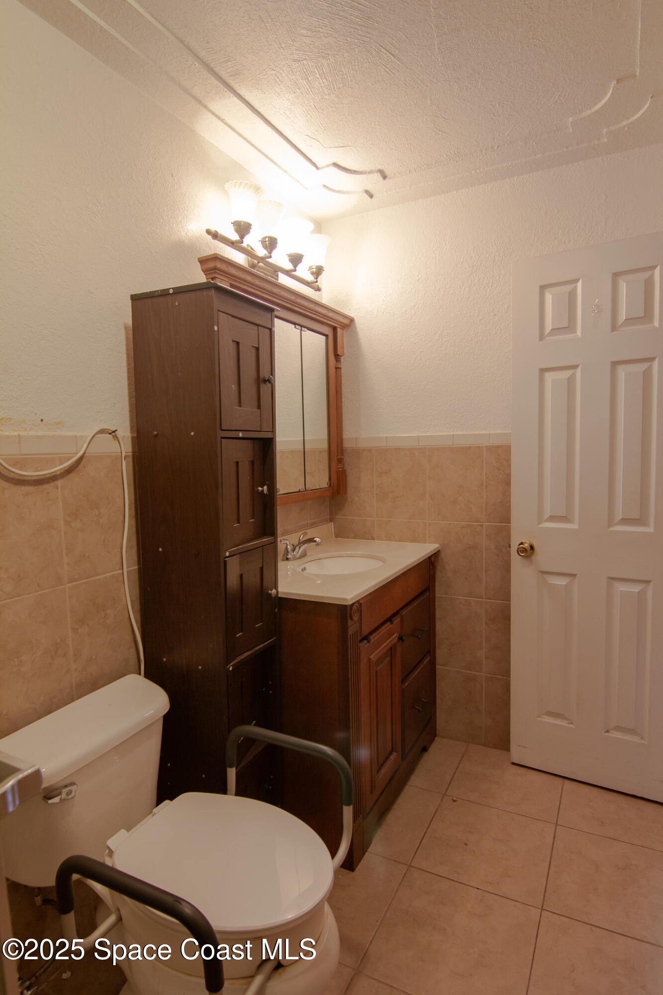 981 Palmer Street Rockledge, FL 32955 - Photo 36 of 38 a bathroom with a granite countertop toilet and a sink