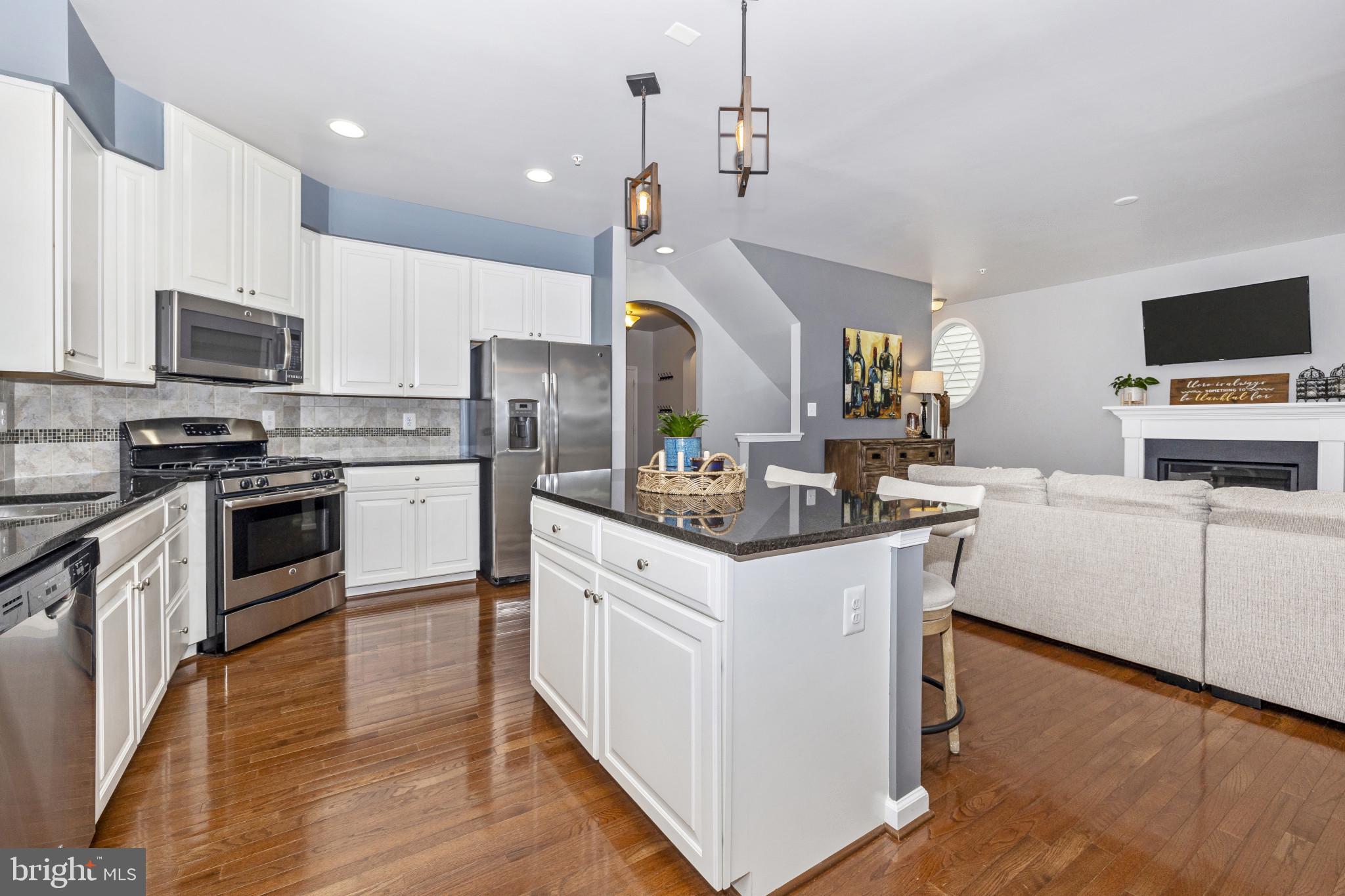 1912 Regiment Way Frederick, MD 21702 - Photo 11 of 45 a kitchen with kitchen island granite countertop a sink a counter top space stainless steel appliances and cabinets