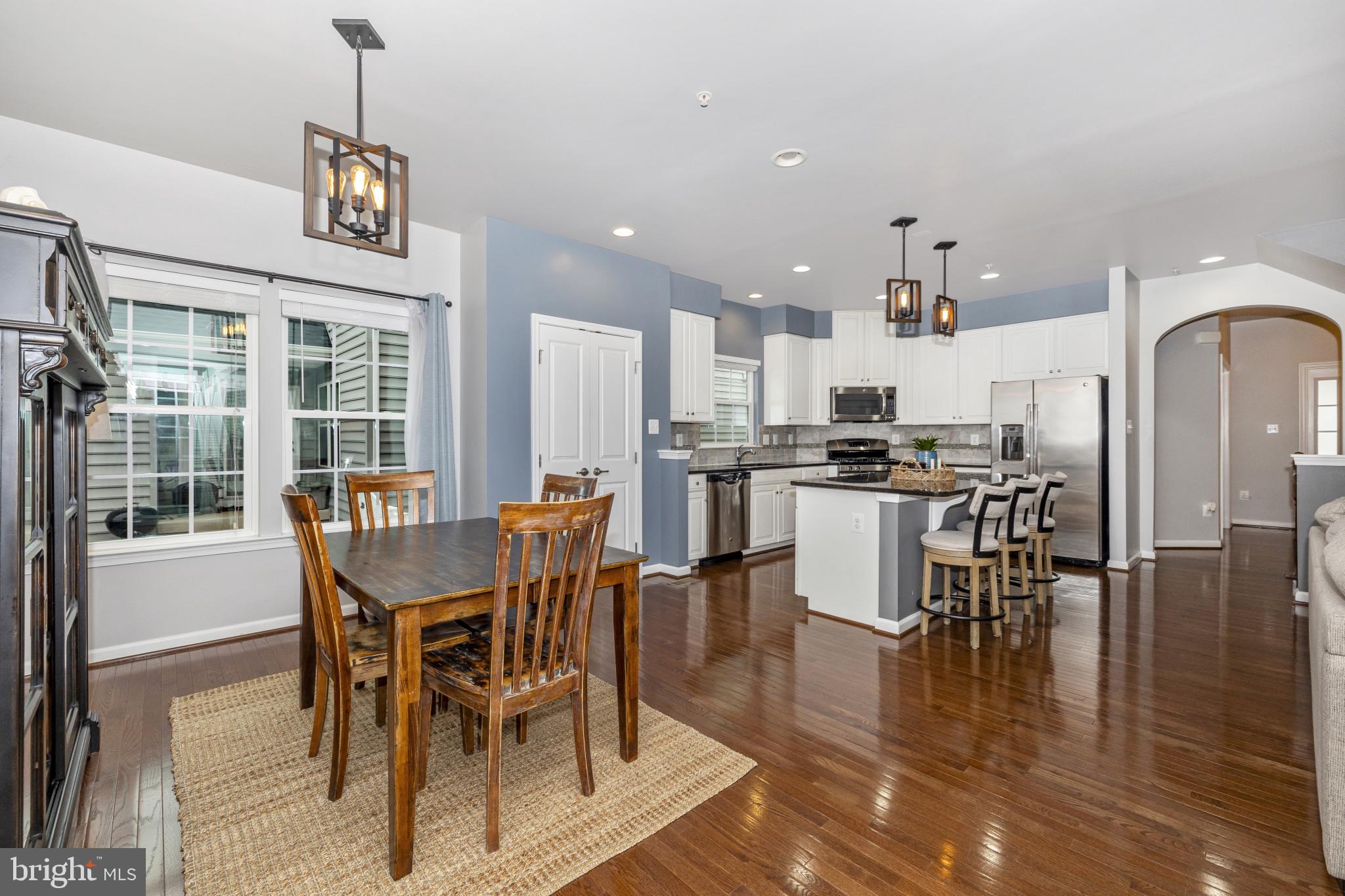 1912 Regiment Way Frederick, MD 21702 - Photo 15 of 45 a dining area with stainless steel appliances a dining table chairs and chandelier