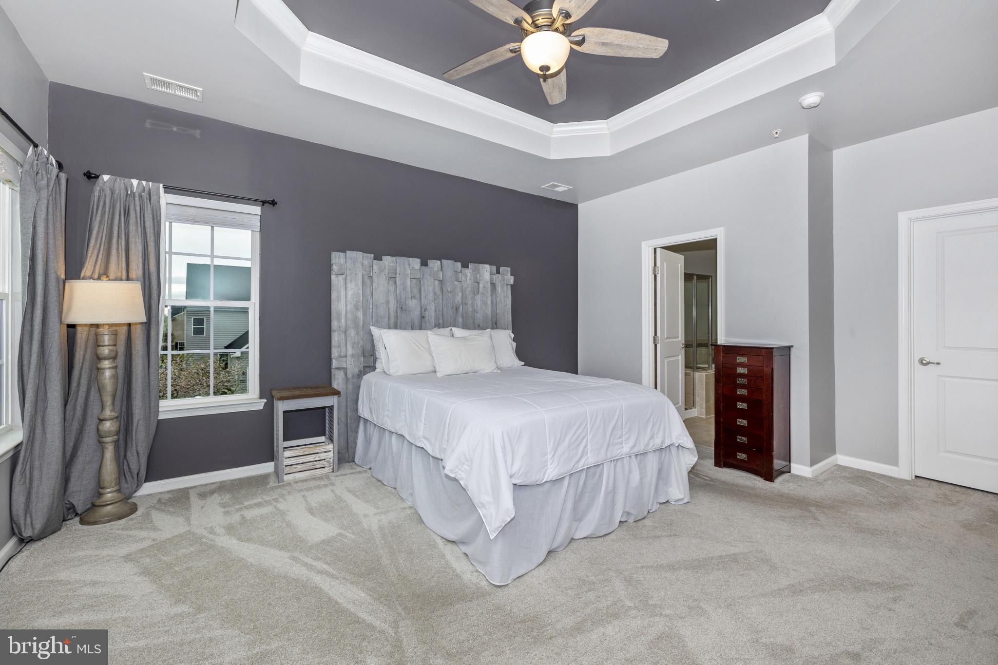 1912 Regiment Way Frederick, MD 21702 - Photo 22 of 45 a bedroom with a large bed and a chandelier