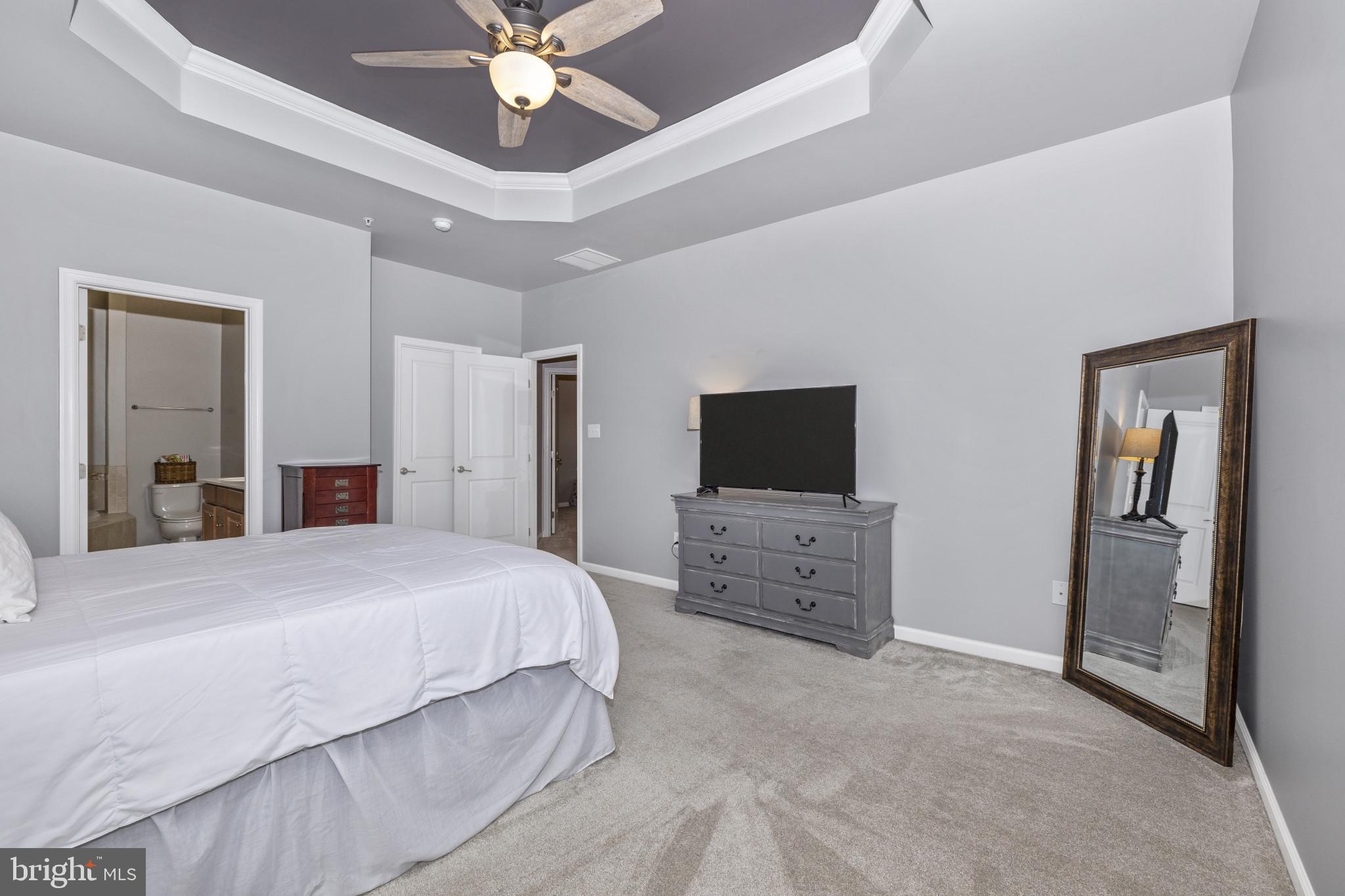 1912 Regiment Way Frederick, MD 21702 - Photo 23 of 45 a spacious bedroom with a bed and a flat screen tv