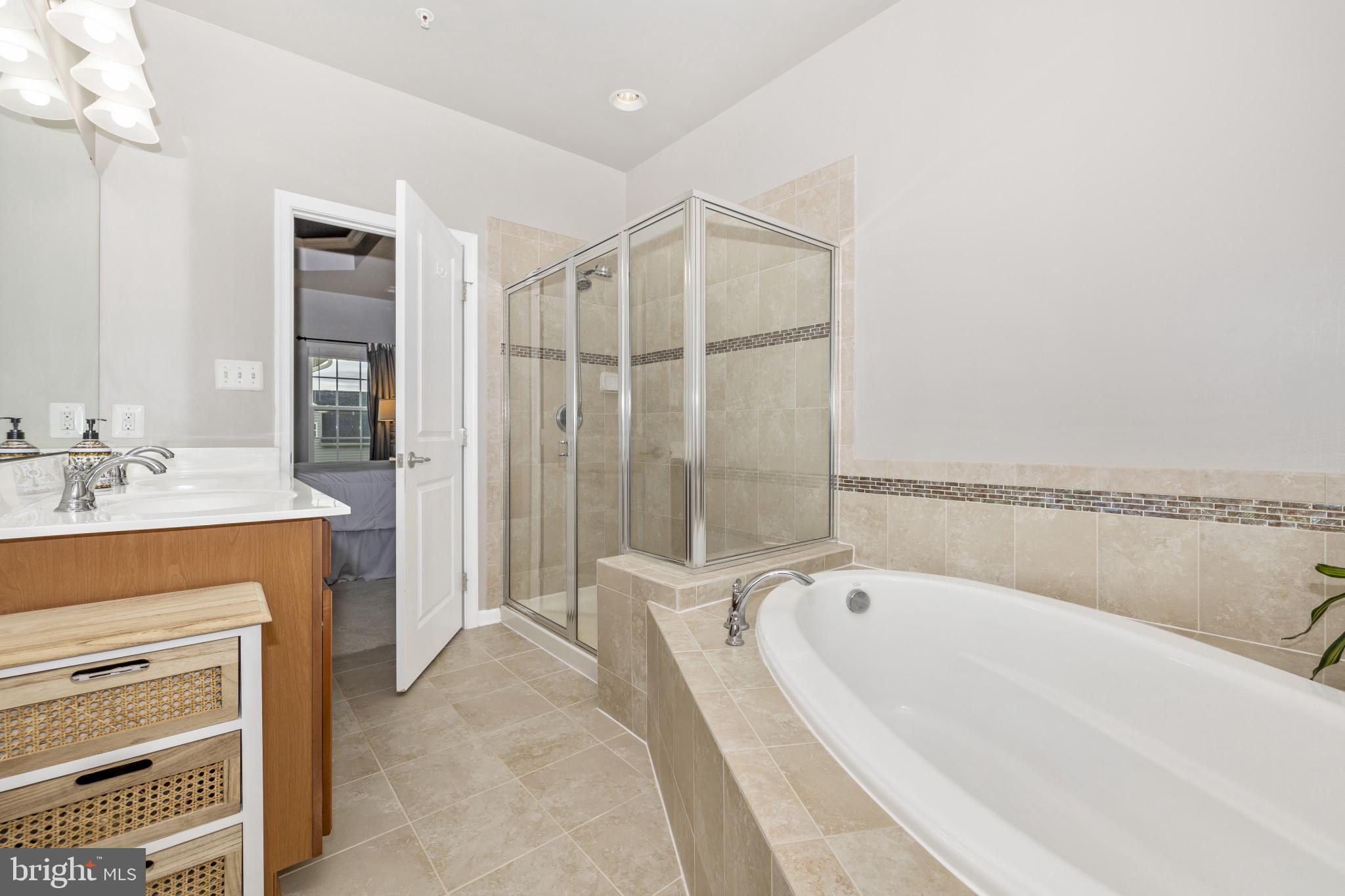 1912 Regiment Way Frederick, MD 21702 - Photo 27 of 45 a spacious bathroom with a tub shower and a sink