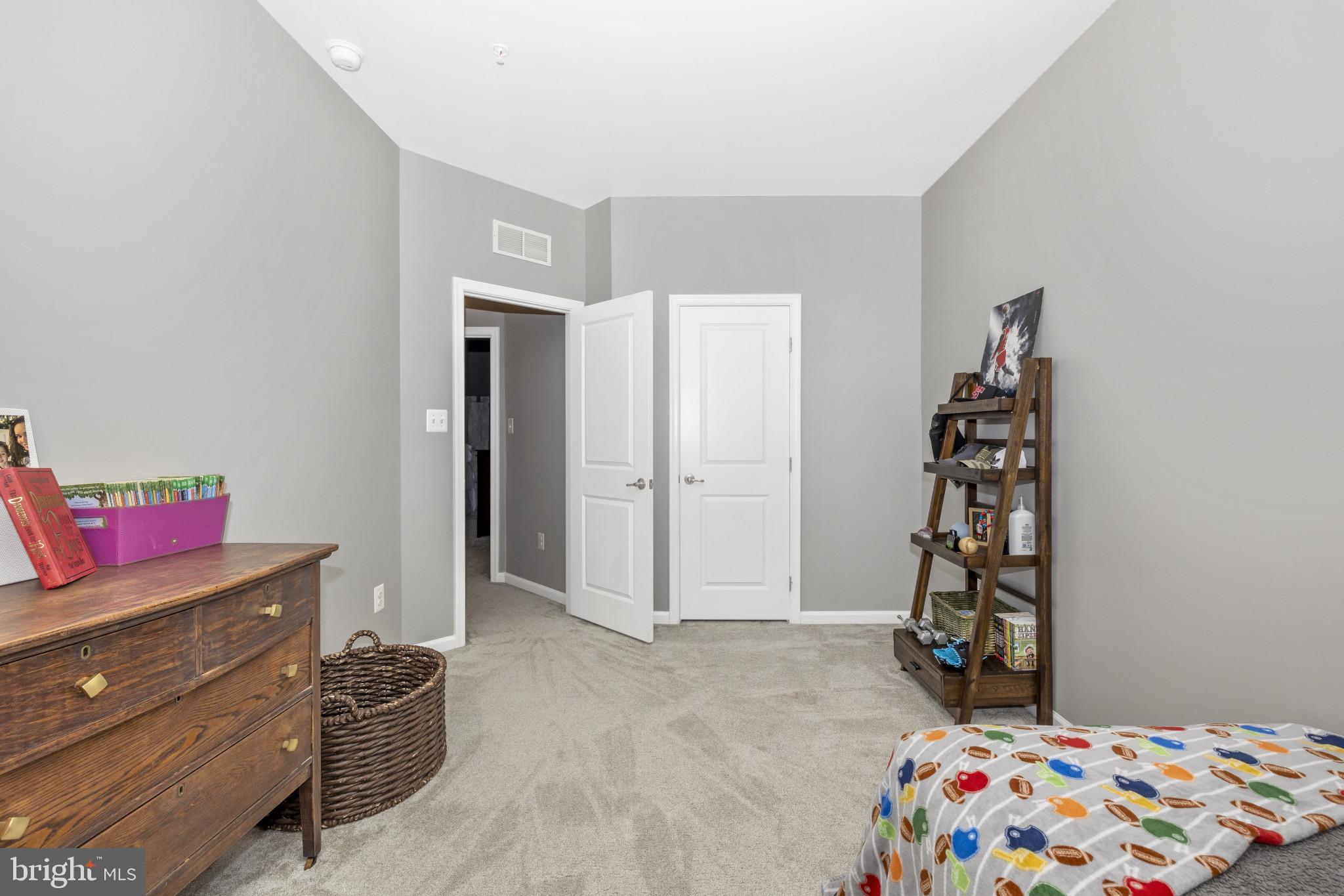 1912 Regiment Way Frederick, MD 21702 - Photo 29 of 45 a bedroom with a bed and a dresser in it