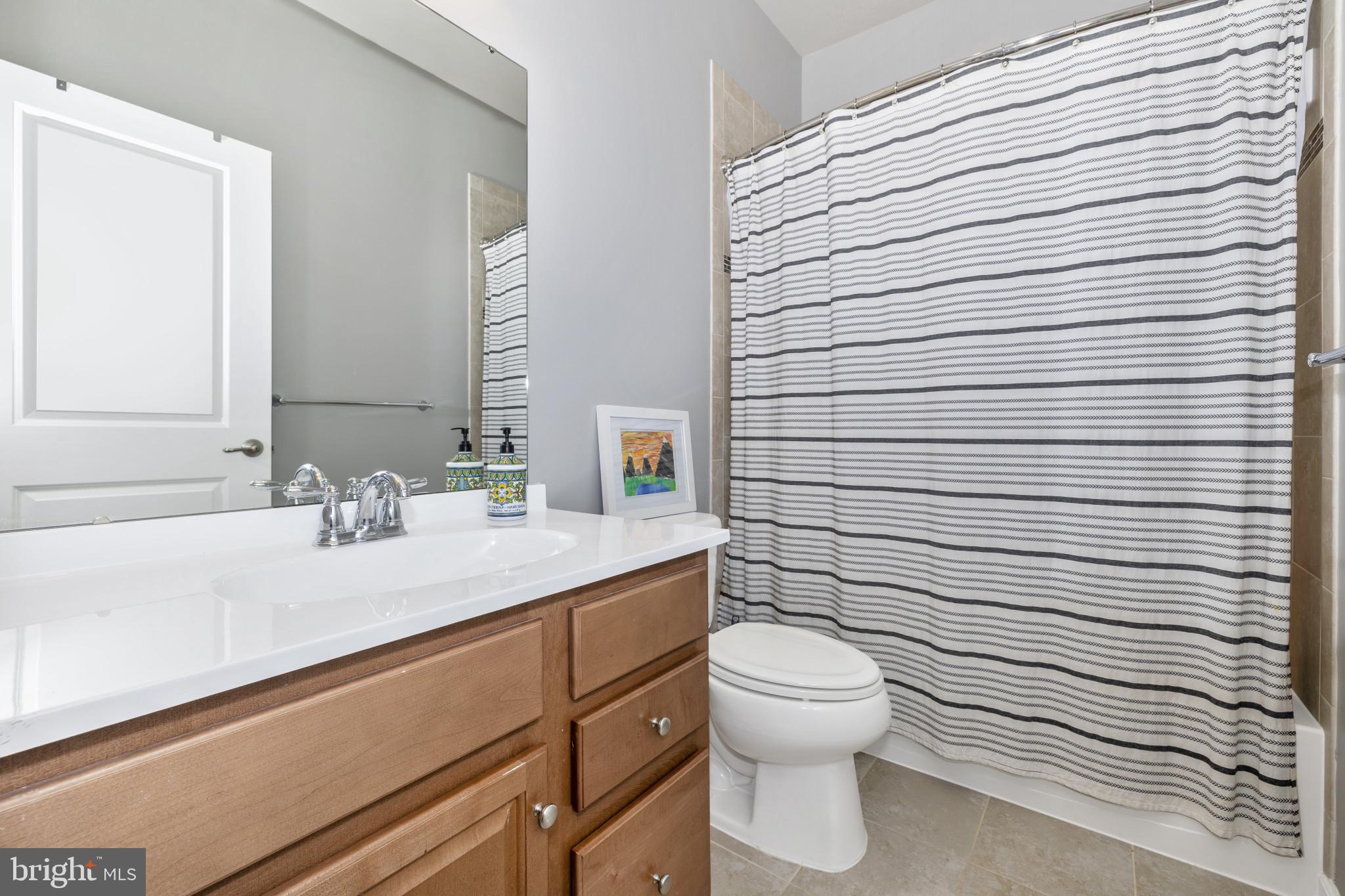 1912 Regiment Way Frederick, MD 21702 - Photo 32 of 45 a bathroom with a sink a toilet and mirror