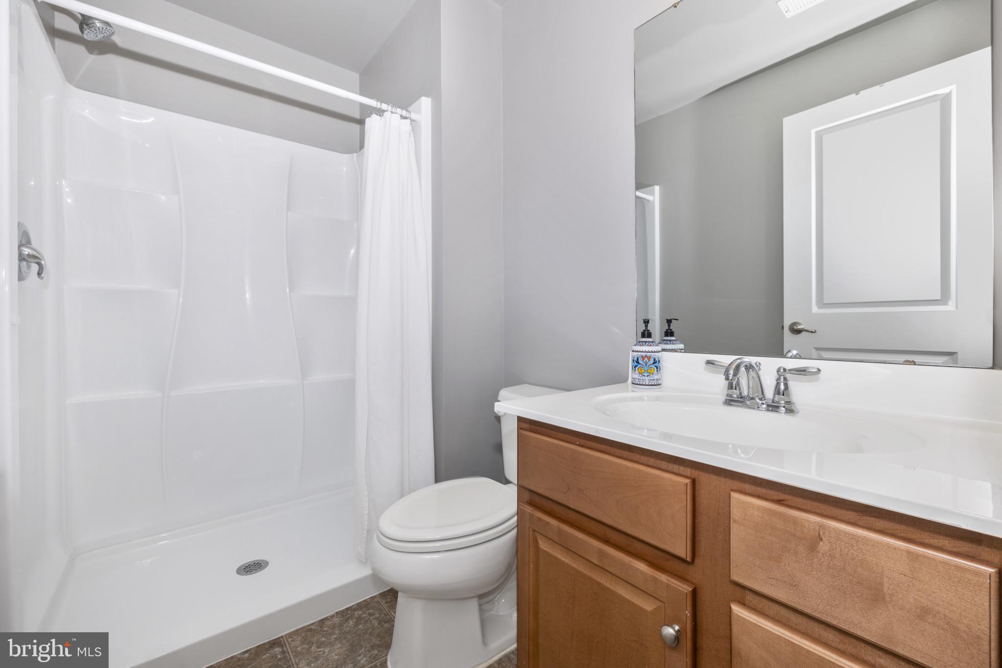 1912 Regiment Way Frederick, MD 21702 - Photo 38 of 45 a bathroom with a sink a toilet and shower