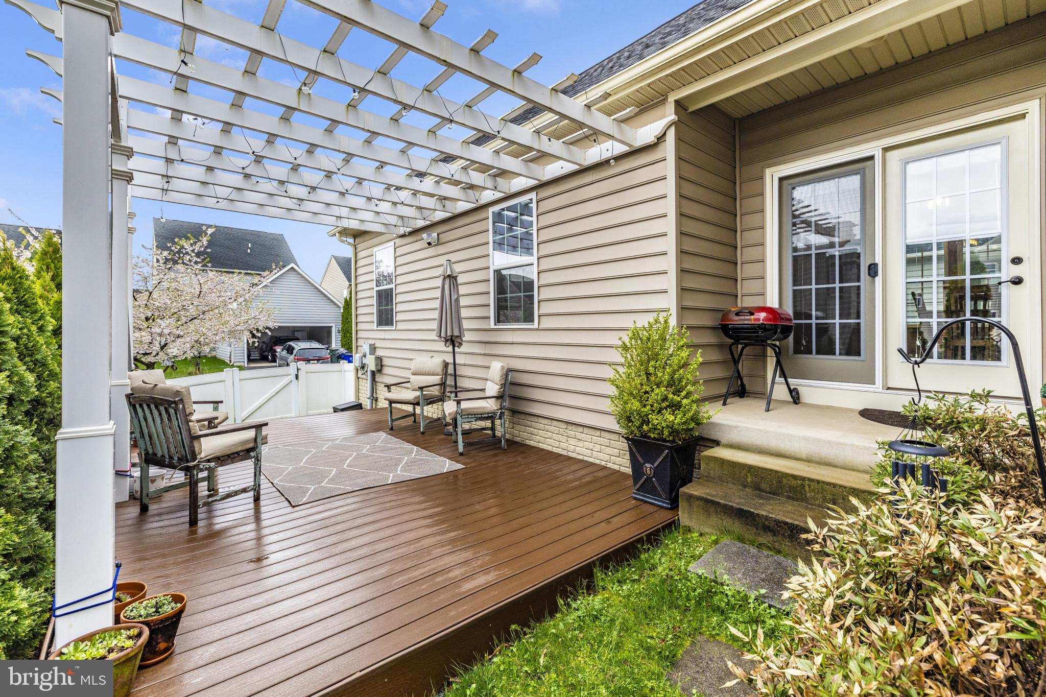 1912 Regiment Way Frederick, MD 21702 - Photo 45 of 45 a view of a deck with table and chairs with wooden floor and plants
