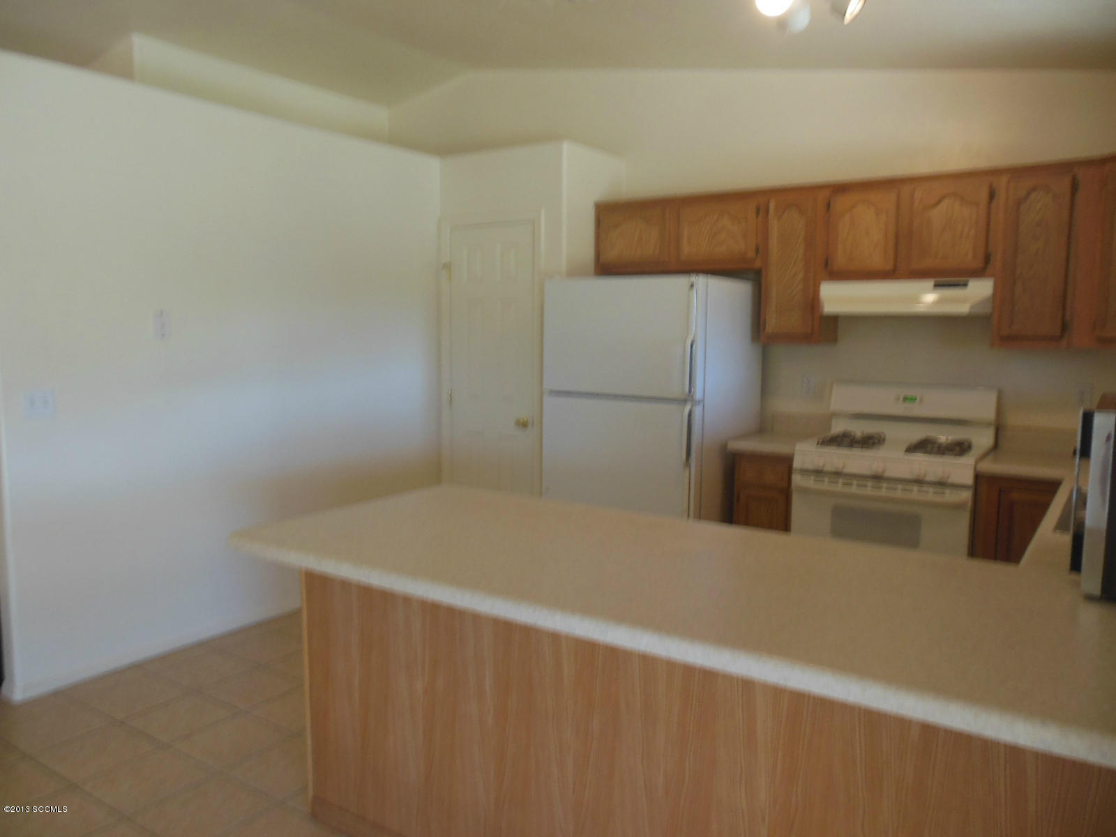 284 Círculo Silva Rio Rico, AZ 85648 - Photo 5 of 19 a kitchen with a refrigerator and a sink