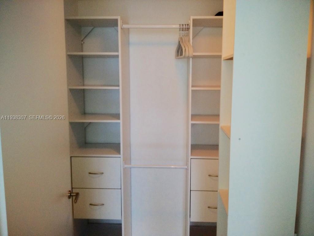 200 Biscayne Blvd Way, Unit 906 Miami, FL 33131 - Photo 12 of 44 a view of walk in closet with empty racks