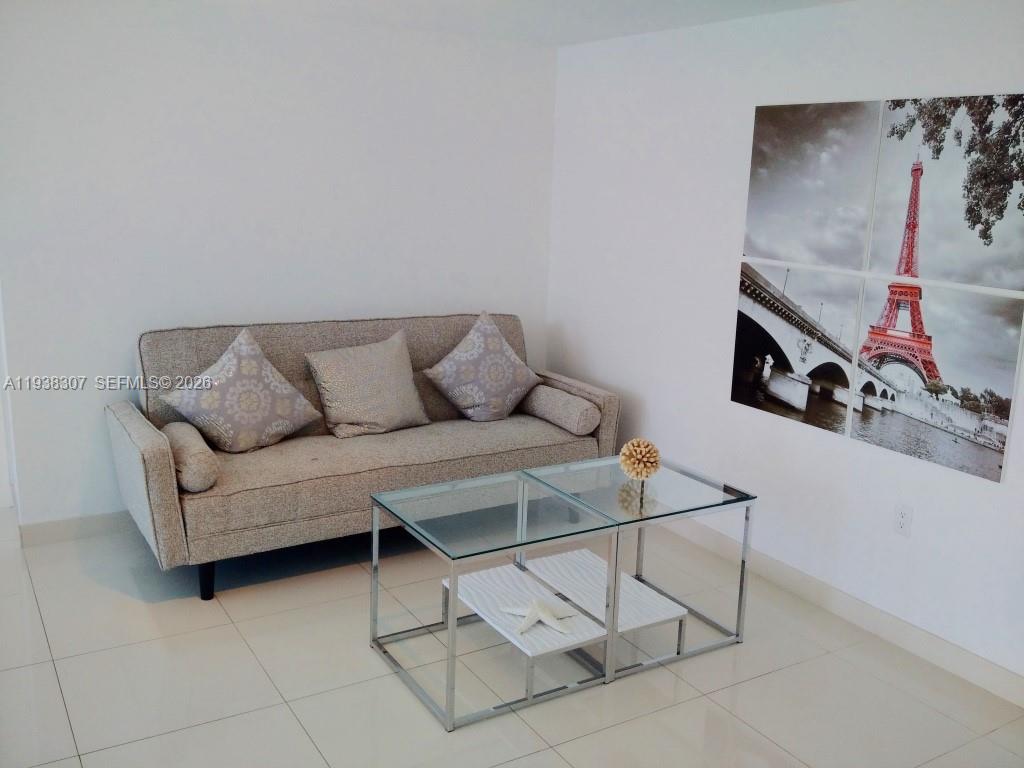 200 Biscayne Blvd Way, Unit 906 Miami, FL 33131 - Photo 14 of 44 a living room with furniture and a couch