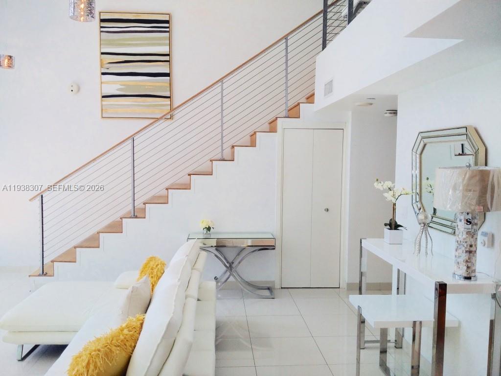 200 Biscayne Blvd Way, Unit 906 Miami, FL 33131 - Photo 22 of 44 a view of a staircase and living room with furniture