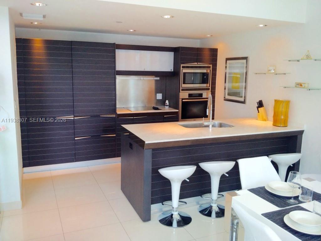 200 Biscayne Blvd Way, Unit 906 Miami, FL 33131 - Photo 29 of 44 a room with a table chairs and entryway