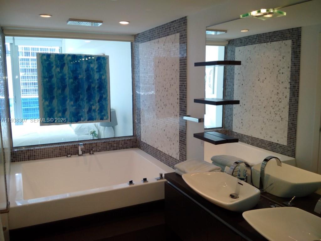 200 Biscayne Blvd Way, Unit 906 Miami, FL 33131 - Photo 8 of 44 a bathroom with a bathtub and a sink