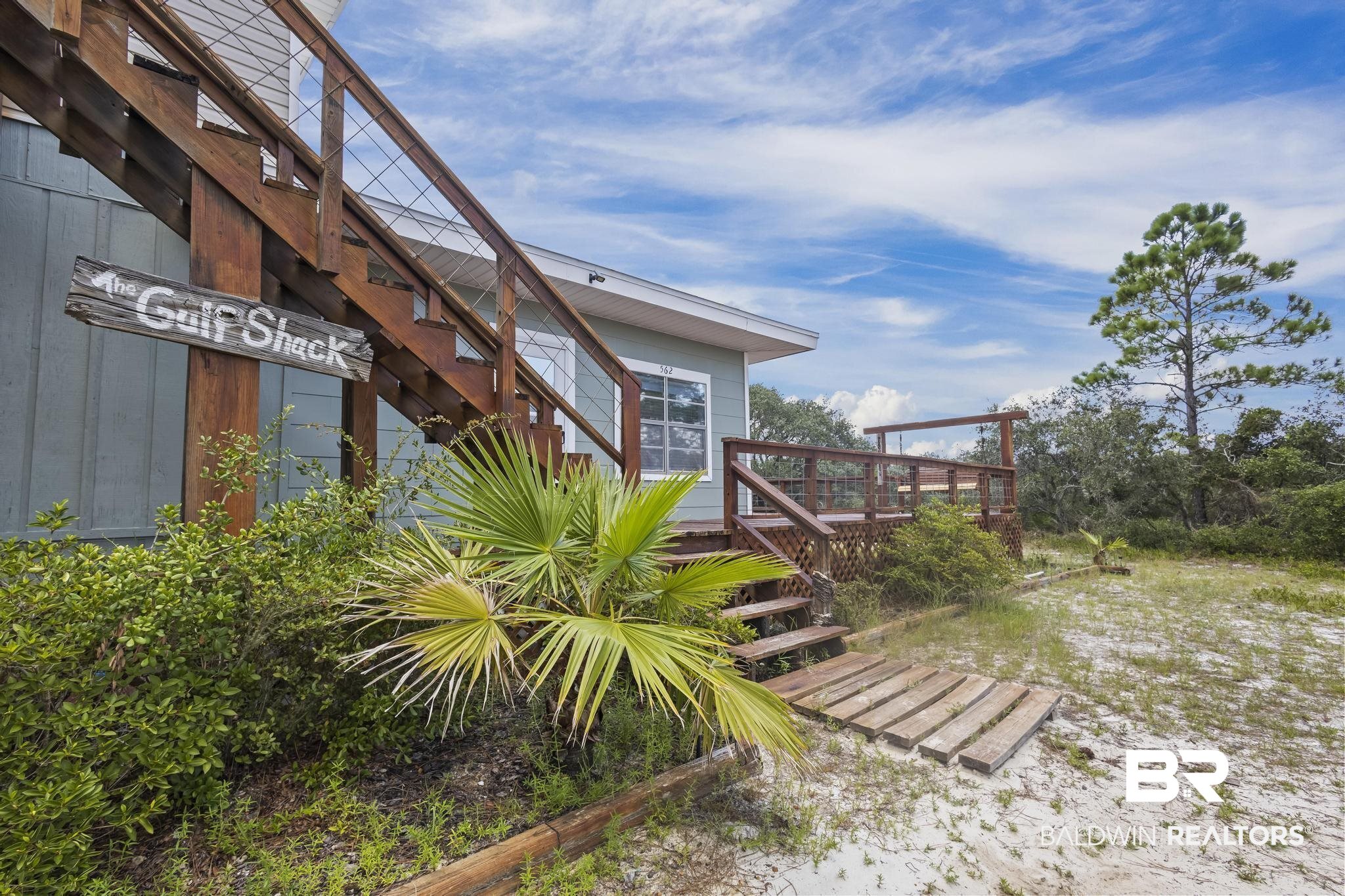 562 Veterans Road Gulf Shores, AL 36542 - Photo 32 of 32 View of yard with a deck and stairway