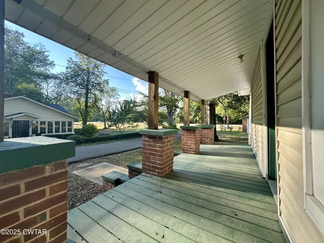 a view of a patio with dining table and chairs