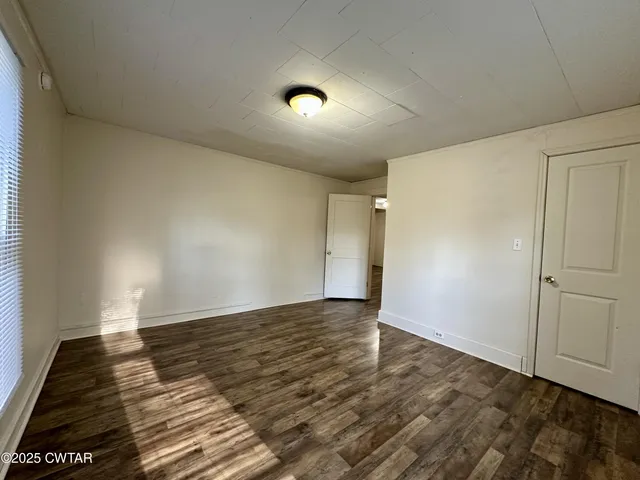 a view of an empty room and wooden floor