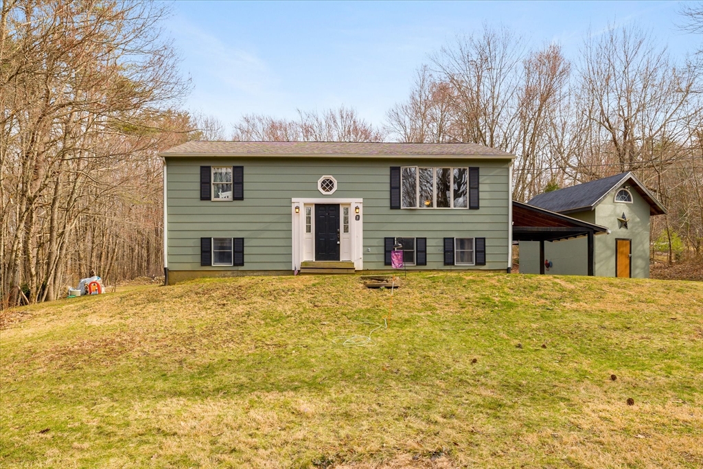 7 Hebert Road Spencer, MA 01562 - Photo 1 of 32 a front view of house with yard and trees around