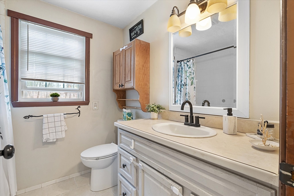 7 Hebert Road Spencer, MA 01562 - Photo 12 of 32 a bathroom with a sink a toilet and a mirror