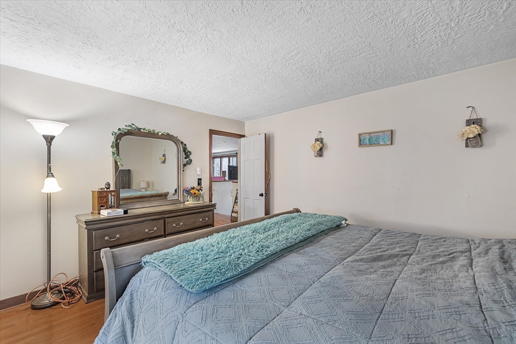 7 Hebert Road Spencer, MA 01562 - Photo 15 of 32 a bedroom with a bed and a dresser with mirror