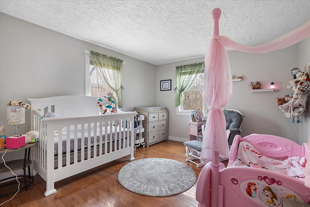 7 Hebert Road Spencer, MA 01562 - Photo 16 of 32 a bedroom with a bed and wooden floor