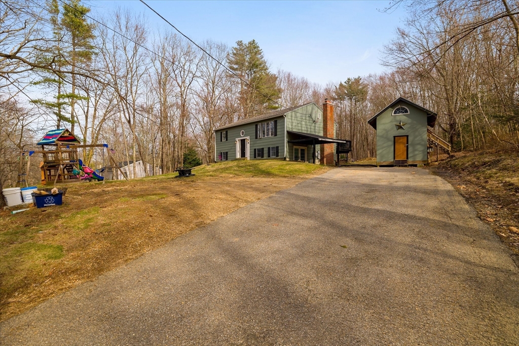 7 Hebert Road Spencer, MA 01562 - Photo 28 of 32 a front view of residential houses with yard and trees