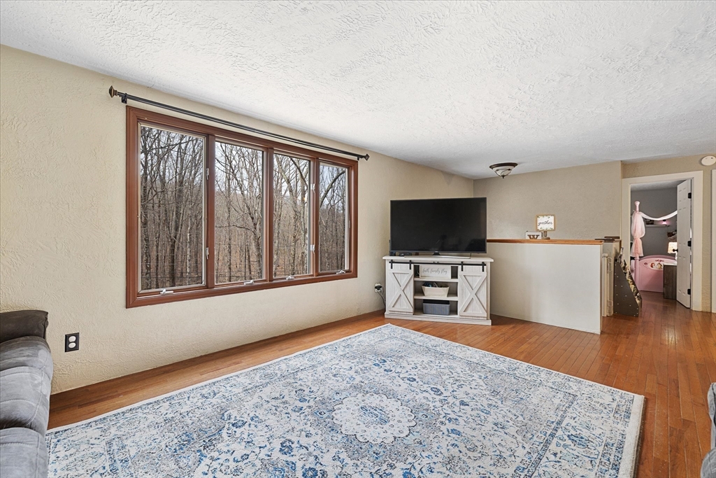 7 Hebert Road Spencer, MA 01562 - Photo 6 of 32 a bedroom with furniture and a flat screen tv