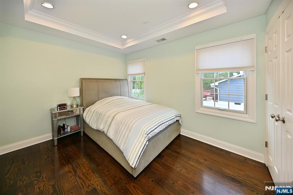 40 Plymouth Road Hillsdale, NJ 07642 - Photo 15 of 33 a bedroom with a bed and wooden floor