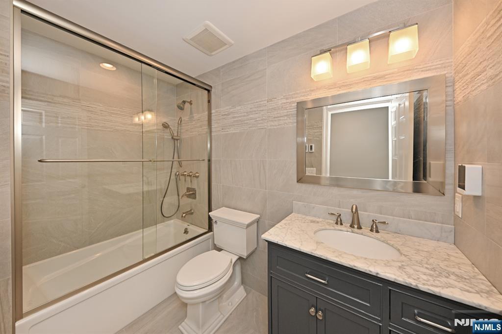 40 Plymouth Road Hillsdale, NJ 07642 - Photo 16 of 33 a bathroom with a granite countertop sink a toilet and shower