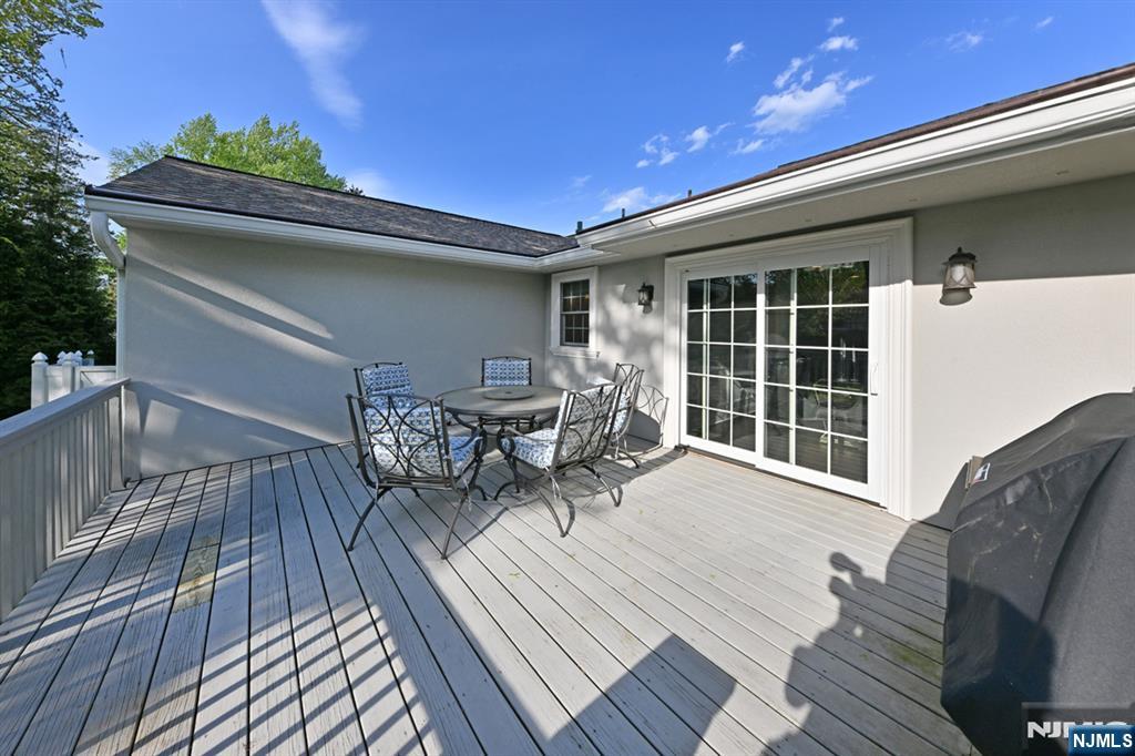 40 Plymouth Road Hillsdale, NJ 07642 - Photo 26 of 33 a view of a patio with table and chairs and wooden floor