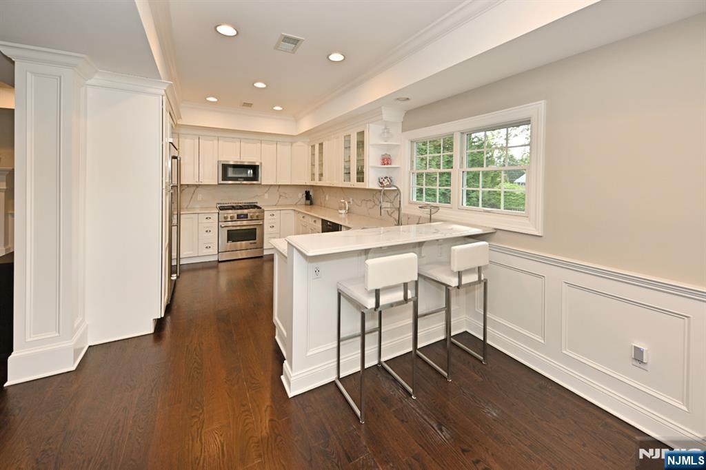 40 Plymouth Road Hillsdale, NJ 07642 - Photo 8 of 33 a kitchen with wooden floors and appliances