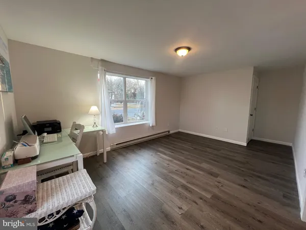 a view of a livingroom with furniture and wooden floor