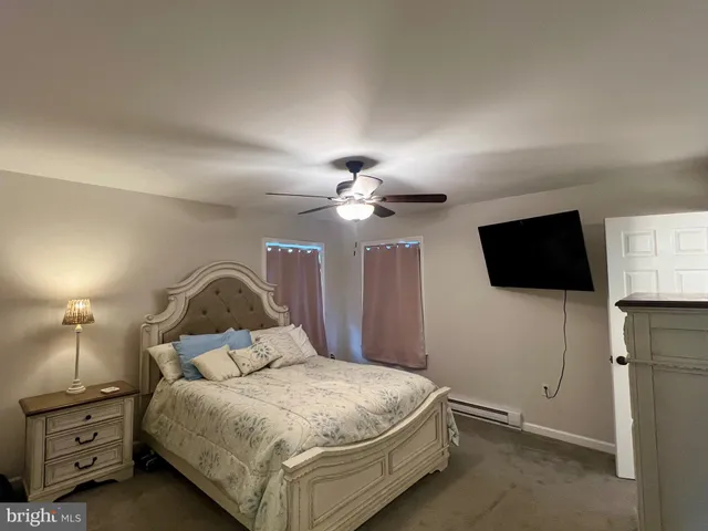 a view of a room with wooden floor and a window