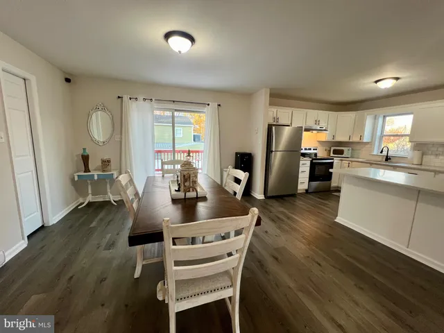 a view of a room with wooden floor and furniture