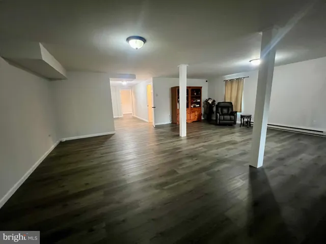 a view of a street with wooden fence