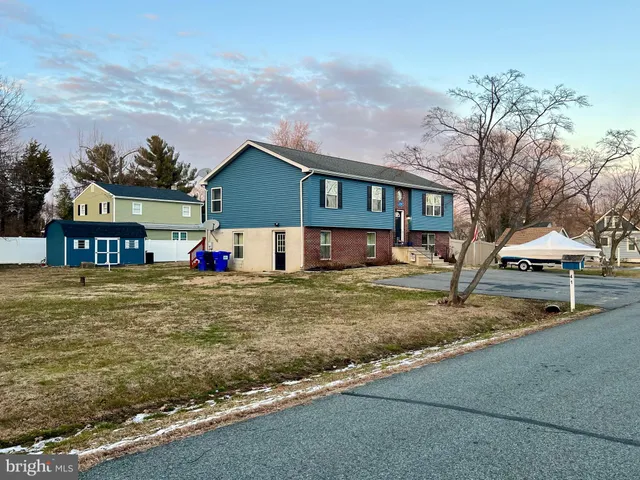 a view of a house with a yard and sitting area