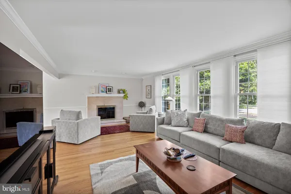 a living room with furniture fireplace and window