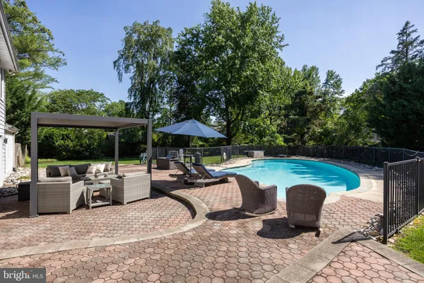a view of backyard with seating space and trees
